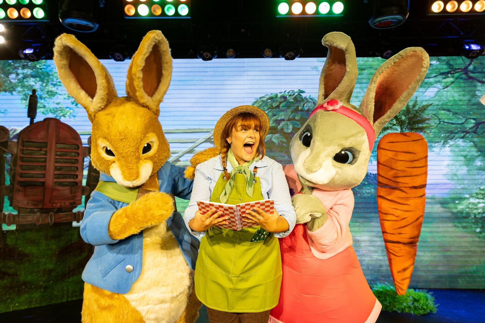 Gardener reading a story with Peter Rabbit and Lily in Peter Rabbit 'In The Garden' live show